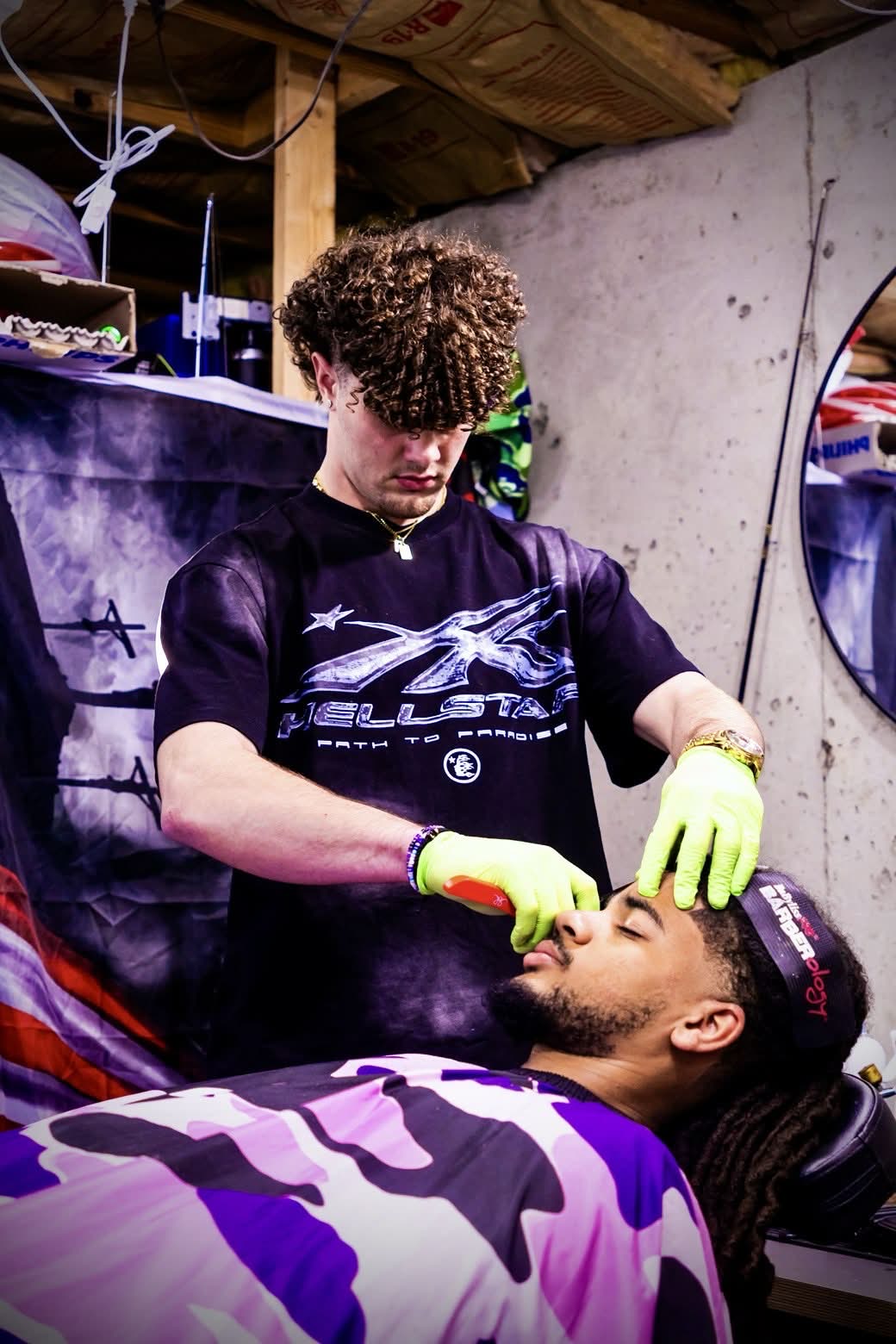 Ryan shaping a client's beard during a cut