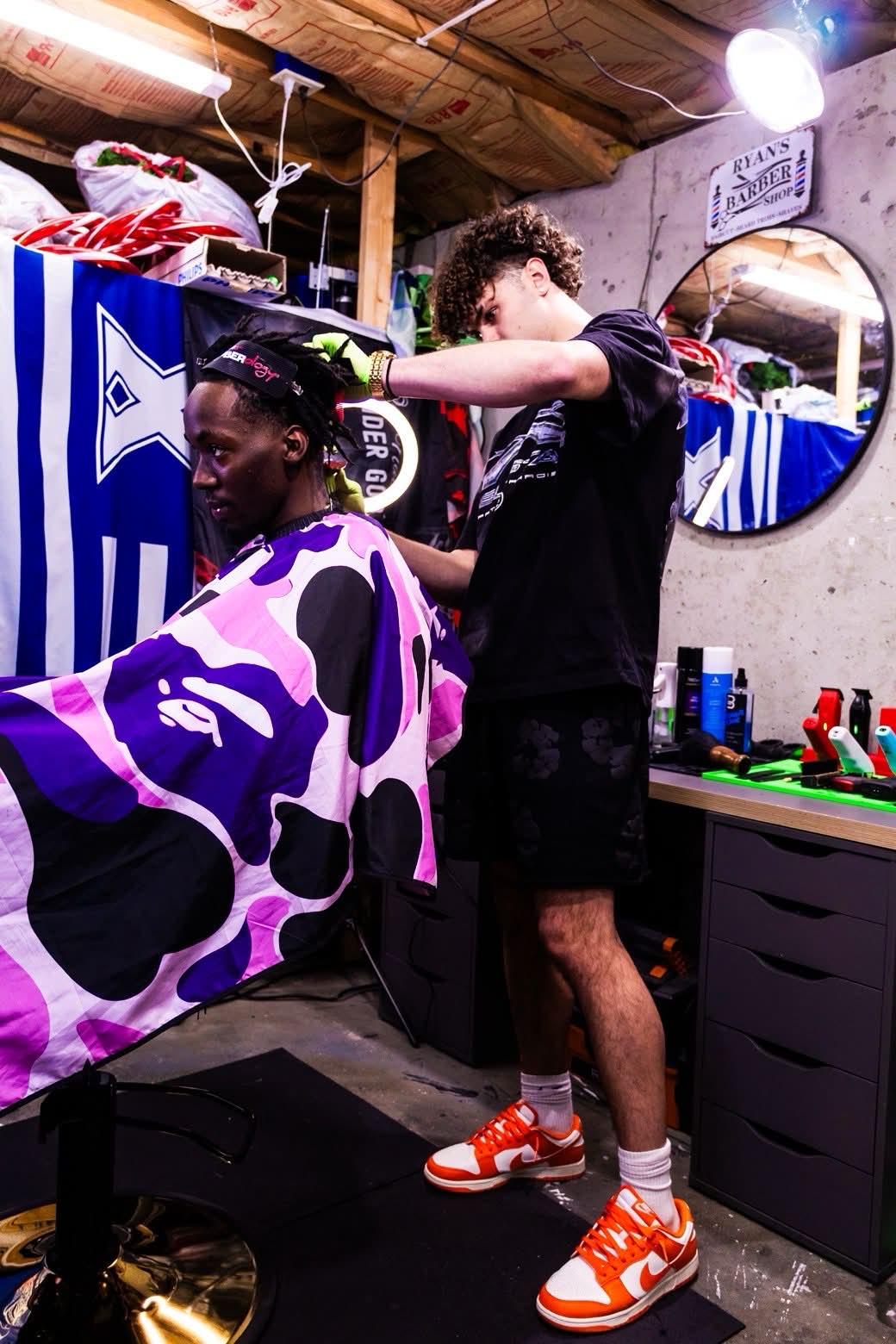 Ryan working in his barbershop with a client